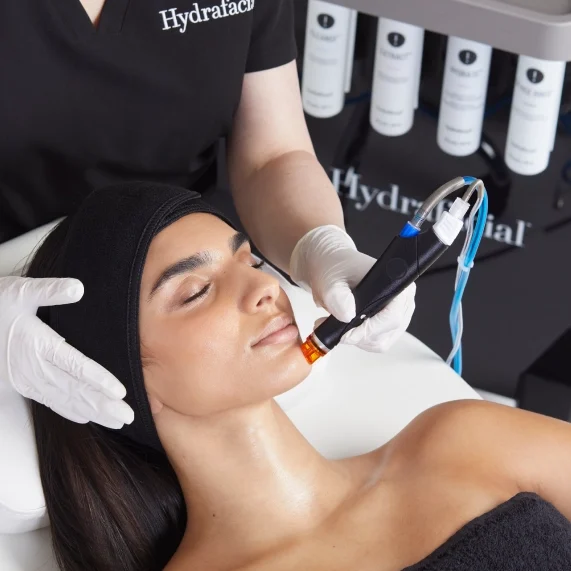 A woman getting her face waxed at the hydrafacial spa.